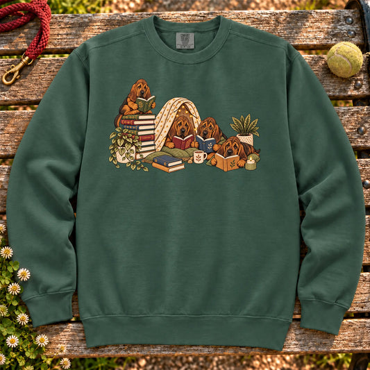 Bloodhound puppies reading books in a cozy blanket fort on a Blue Spruce sweatshirt