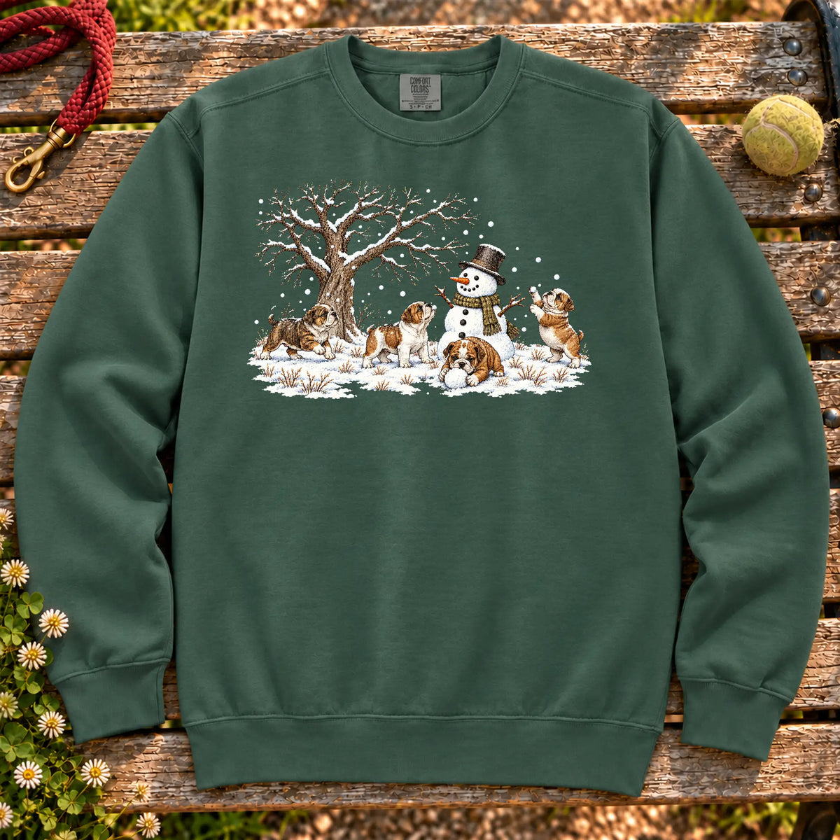 Bulldog puppies playing in snow with a snowman on a Blue Spruce sweatshirt