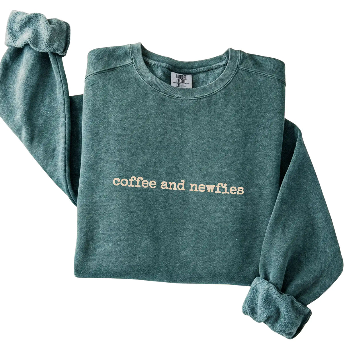 Blue Spruce Coffee and Newfies Comfort Colors sweatshirt folded to show the printed design