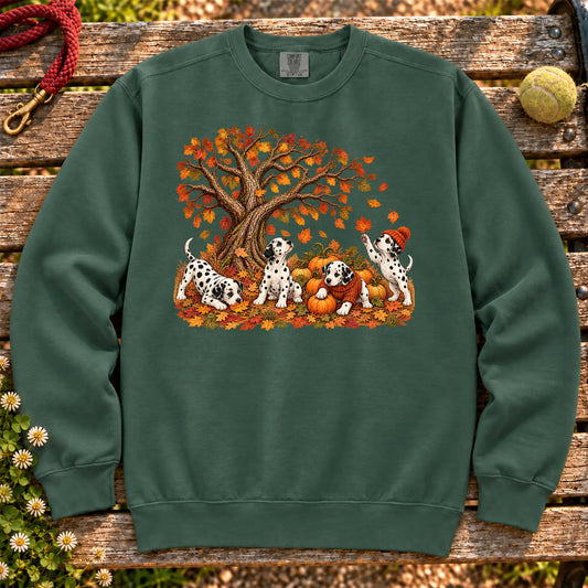 Four Dalmatian puppies with pumpkins beneath an autumn tree on a Blue Spruce garment-dyed sweatshirt