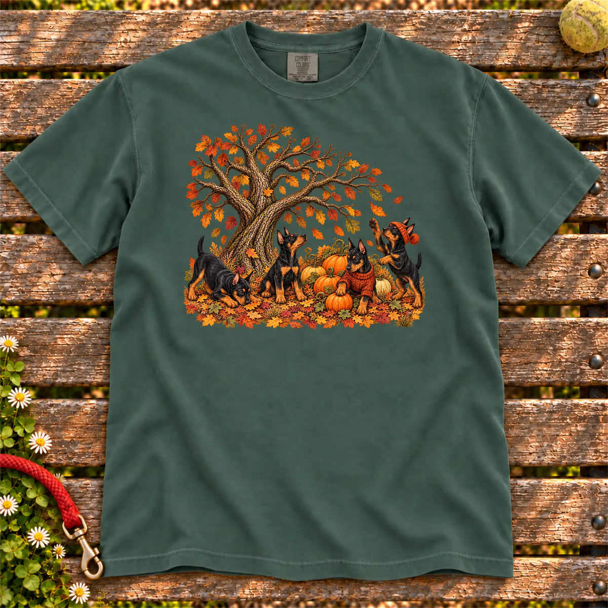Four Doberman puppies with pumpkins beneath an autumn tree on a Blue Spruce garment-dyed T-shirt
