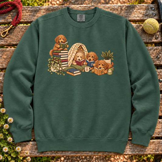 Goldendoodle puppies reading books in a cozy blanket fort on a Blue Spruce sweatshirt