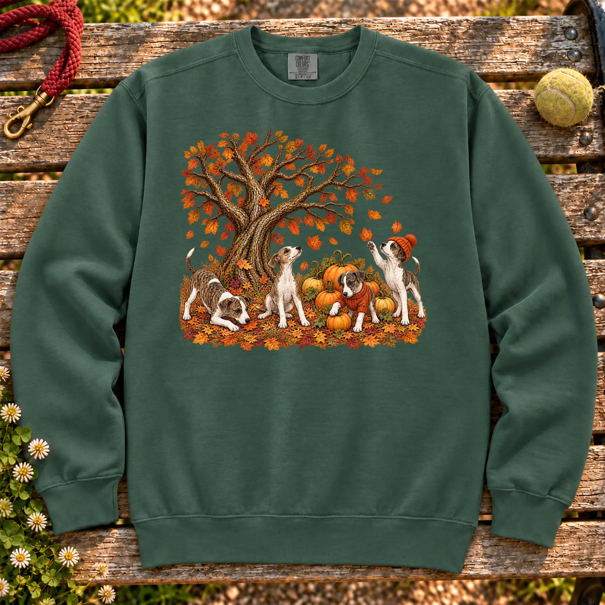 Four Greyhound puppies with pumpkins beneath an autumn tree on a Blue Spruce garment-dyed sweatshirt