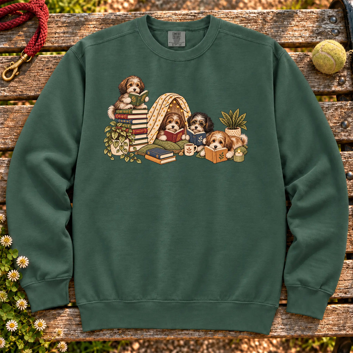 Havanese puppies reading books in a cozy blanket fort on a Blue Spruce sweatshirt