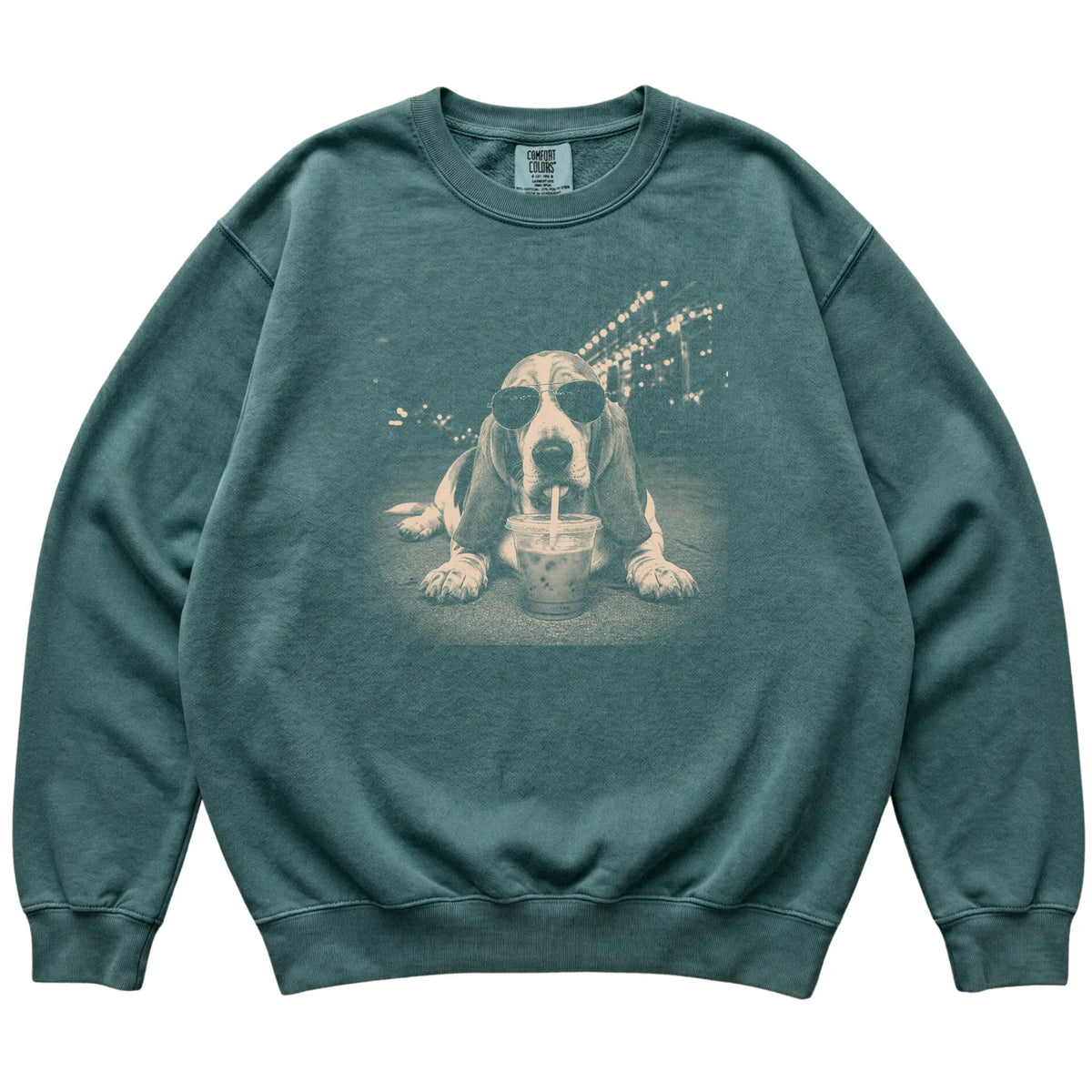 Basset Hound wearing aviator sunglasses and drinking iced coffee on a Blue Spruce Comfort Colors 1566 Sweatshirt, flat lay view