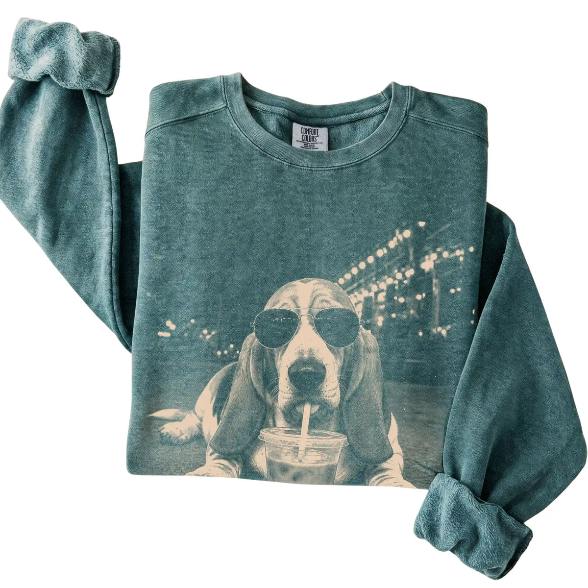 Basset Hound wearing aviator sunglasses and drinking iced coffee on a Blue Spruce Comfort Colors 1566 Sweatshirt, folded view