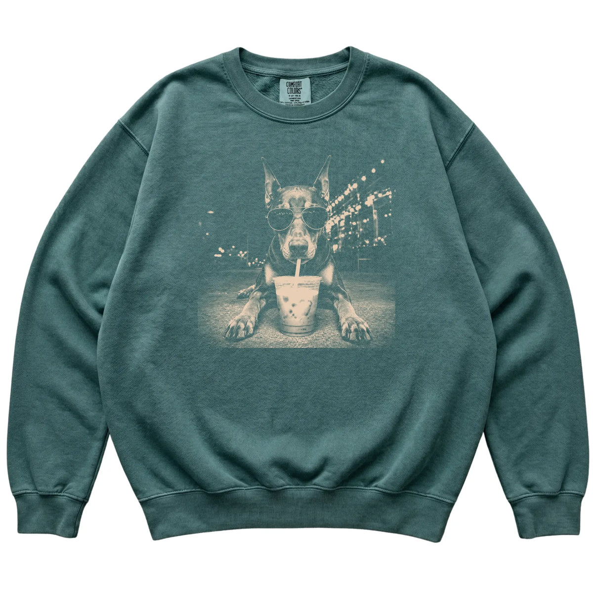 Doberman wearing aviator sunglasses and drinking iced coffee on a Blue Spruce Comfort Colors 1566 Sweatshirt, flat lay view
