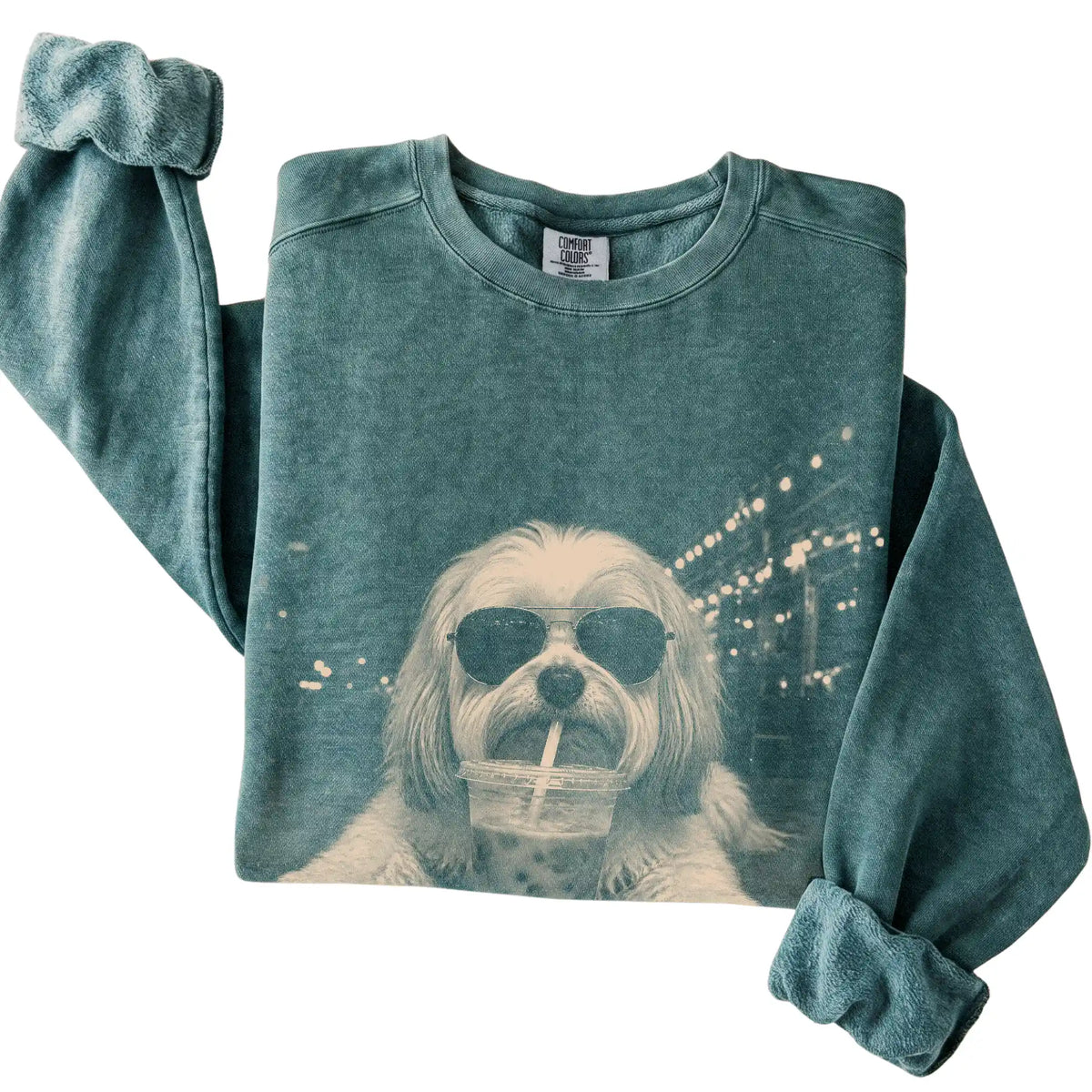 Havanese wearing aviator sunglasses and drinking iced coffee on a Blue Spruce Comfort Colors 1566 Sweatshirt, folded view