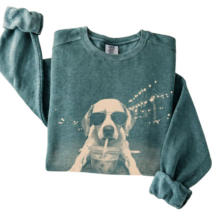 Pointer wearing aviator sunglasses and drinking iced coffee on a Blue Spruce Comfort Colors 1566 Sweatshirt, folded view