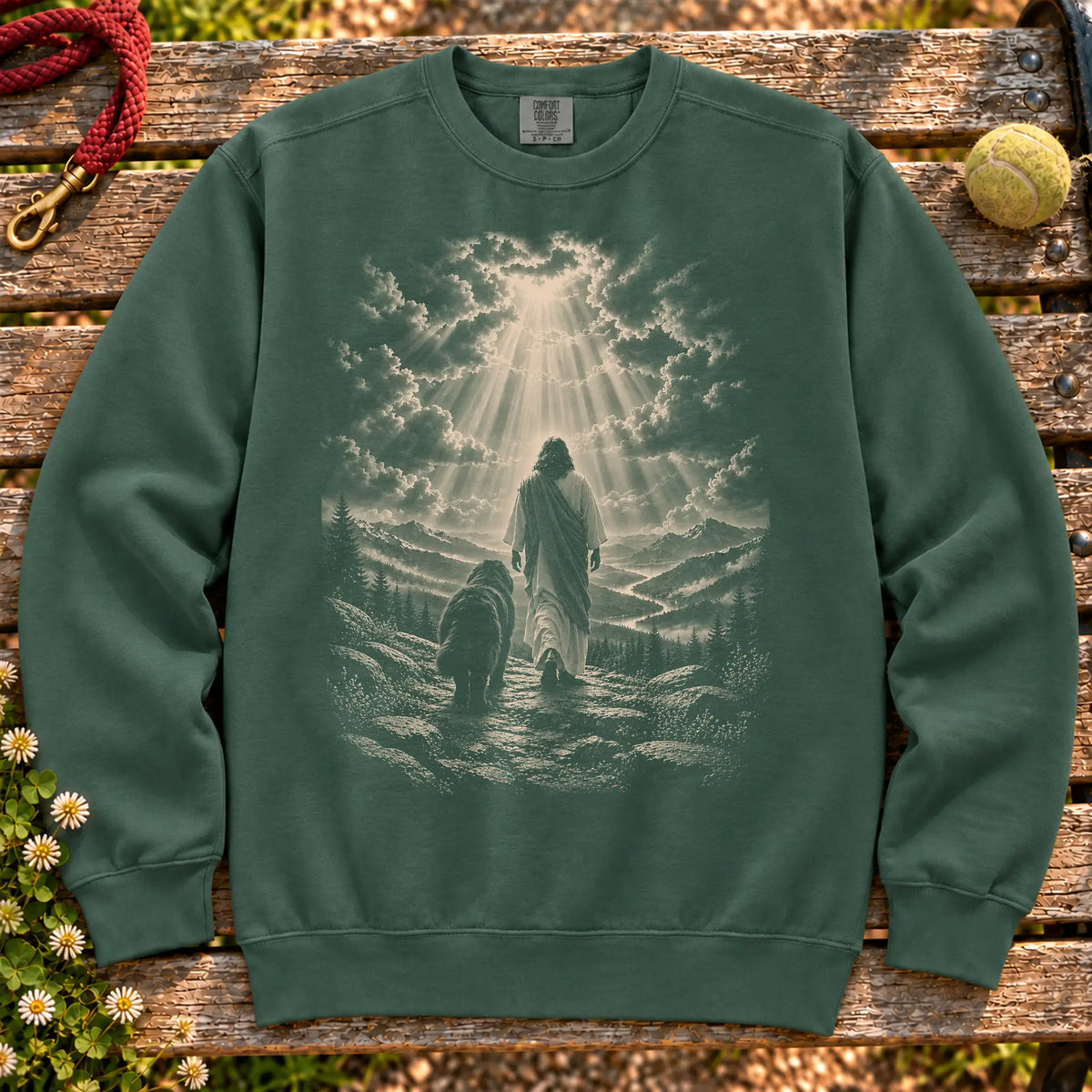 Blue Spruce sweatshirt showing Jesus walking beside a Newfie beneath rays of light