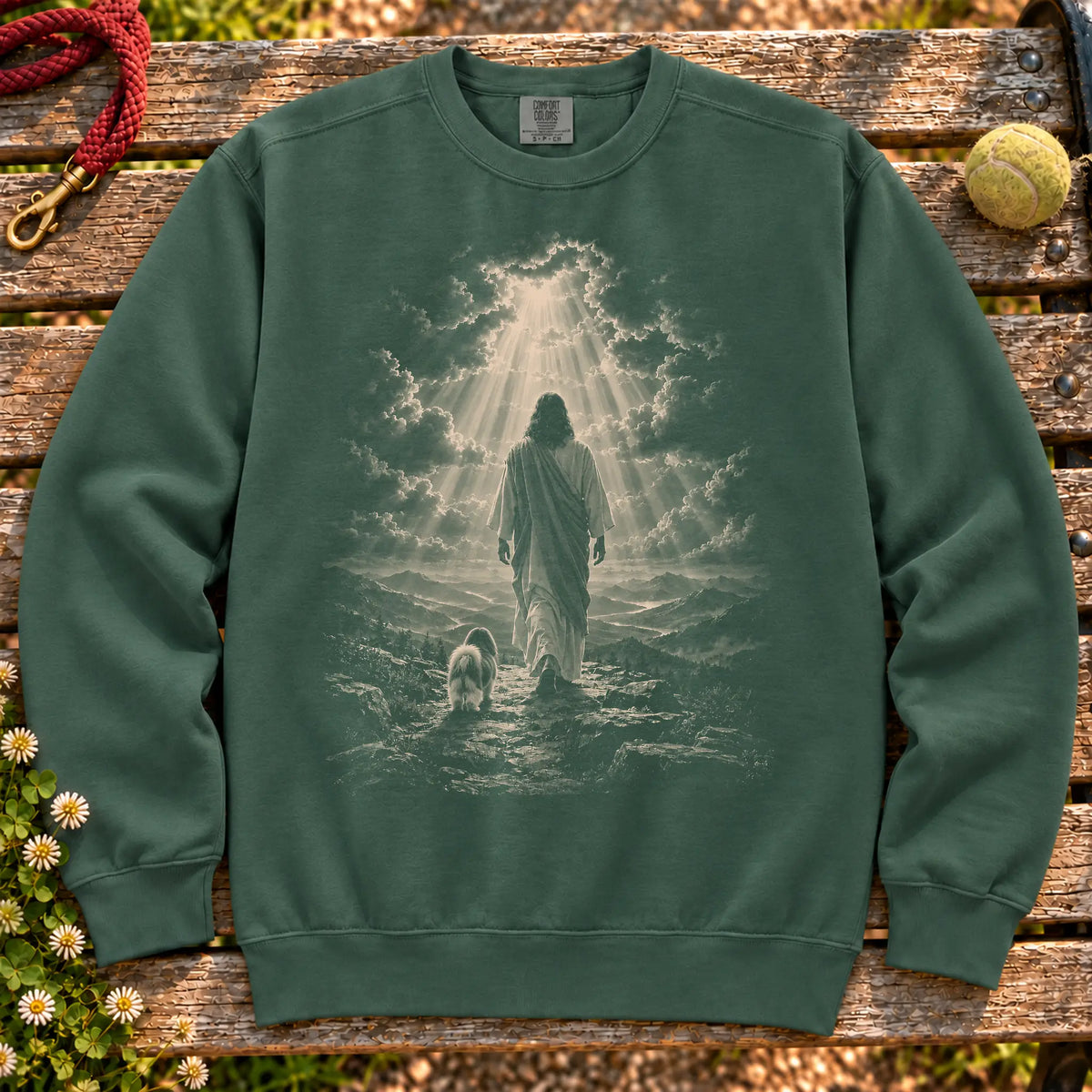 Blue Spruce sweatshirt showing Jesus walking beside a Shih Tzu beneath rays of light