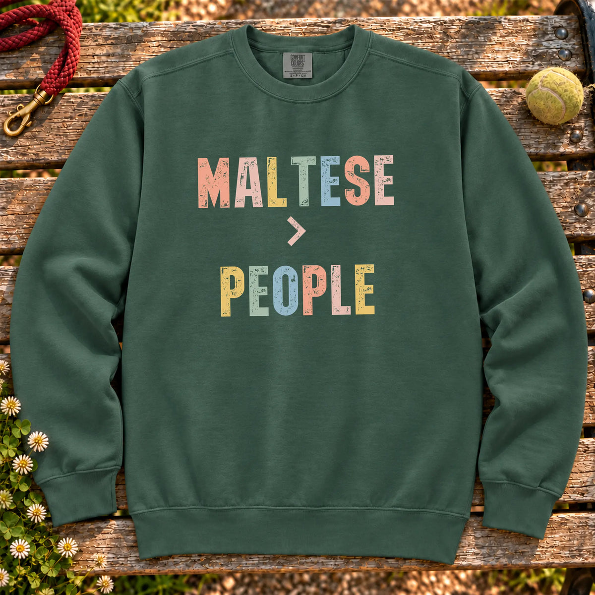 Maltese greater than people text design on a Blue Spruce Comfort Colors sweatshirt