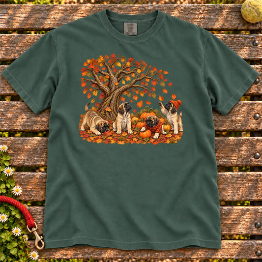 Four Mastiff puppies with pumpkins beneath an autumn tree on a Blue Spruce garment-dyed T-shirt