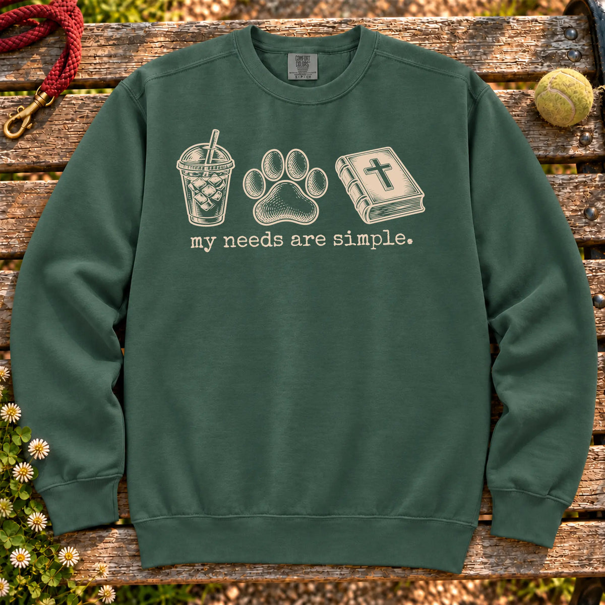 My Needs Are Simple coffee, dogs, and faith design on a Blue Spruce Comfort Colors sweatshirt