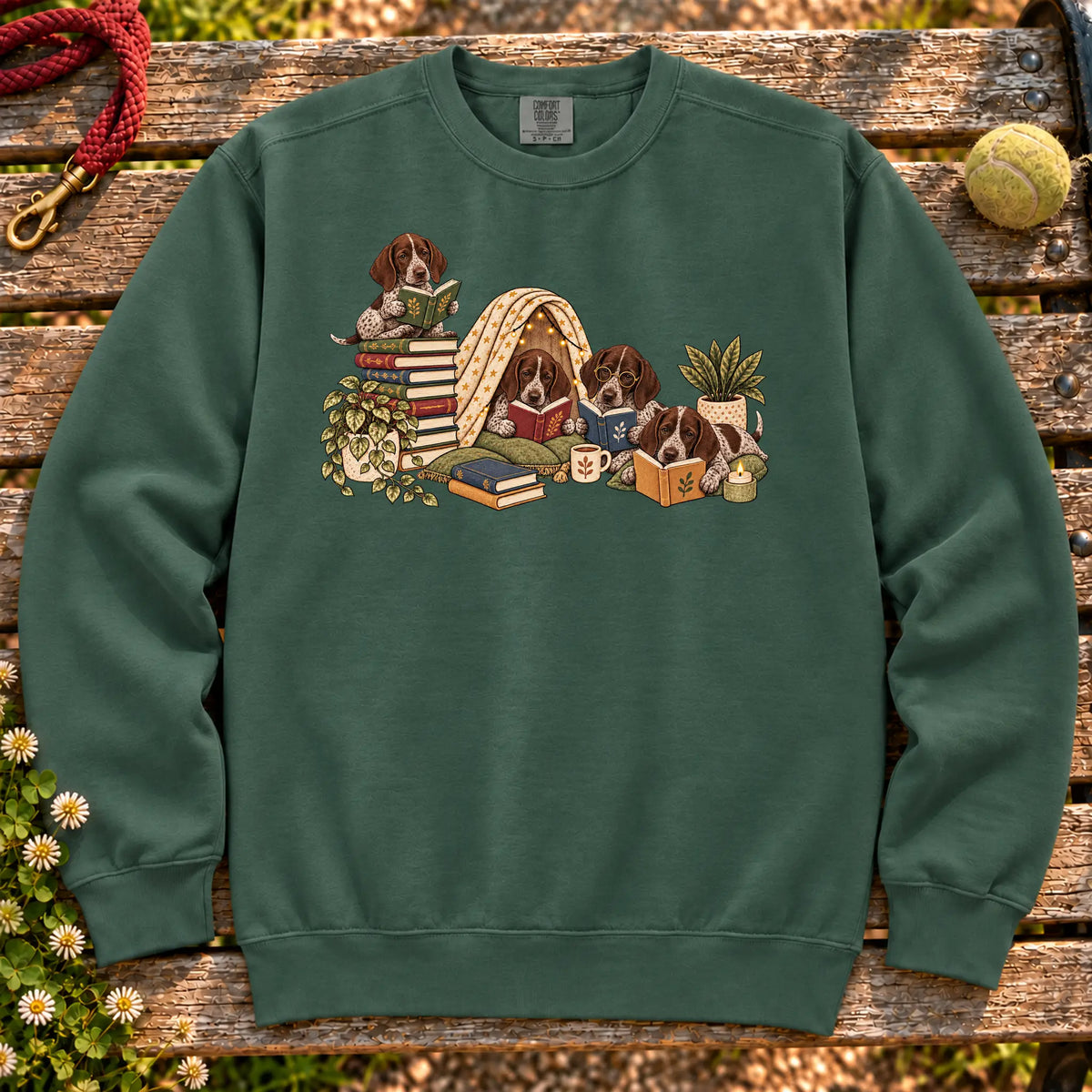 Pointer puppies reading books in a cozy blanket fort on a Blue Spruce sweatshirt