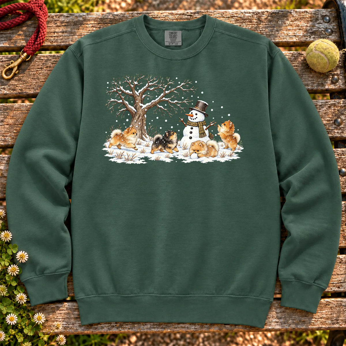 Pomeranian puppies playing in snow with a snowman on a Blue Spruce sweatshirt
