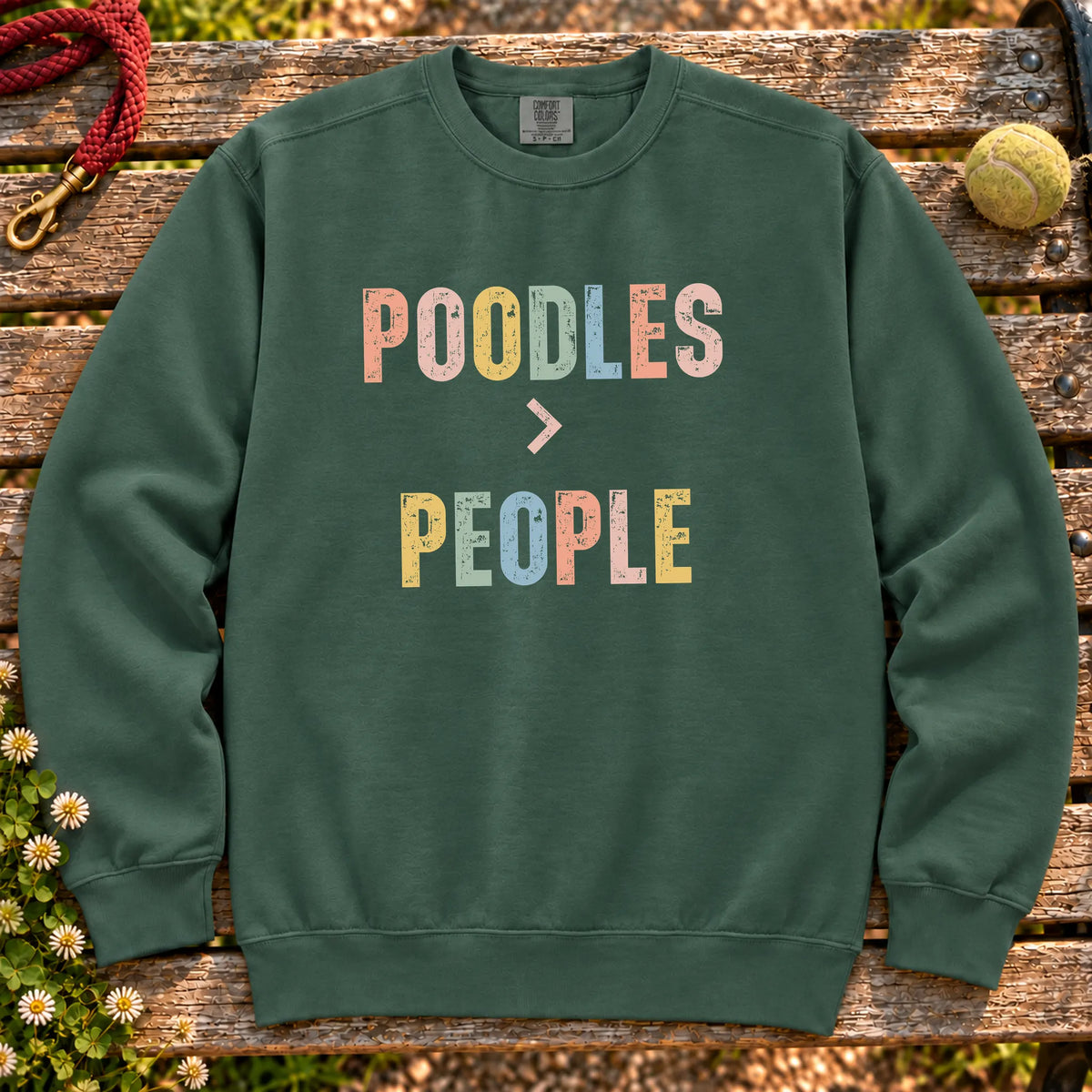 Poodles greater than people text design on a Blue Spruce Comfort Colors sweatshirt