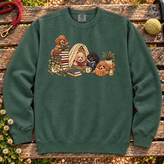 Poodle puppies reading books in a cozy blanket fort on a Blue Spruce sweatshirt