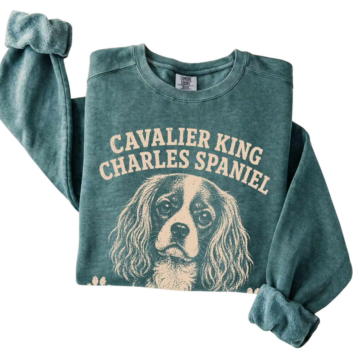 Blue Spruce Comfort Colors® sweatshirt featuring Professionally Affectionate - Cavalier King Charles…, folded presentation