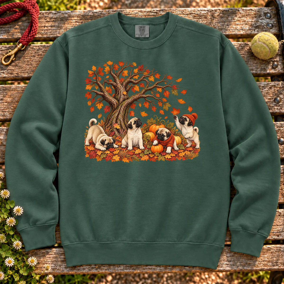 Four Pug puppies with pumpkins beneath an autumn tree on a Blue Spruce garment-dyed sweatshirt