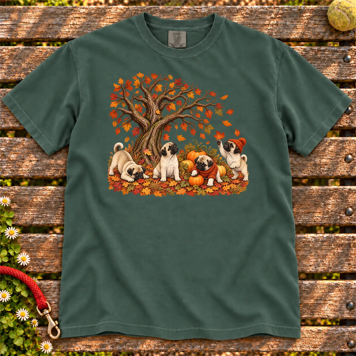 Four Pug puppies with pumpkins beneath an autumn tree on a Blue Spruce garment-dyed T-shirt