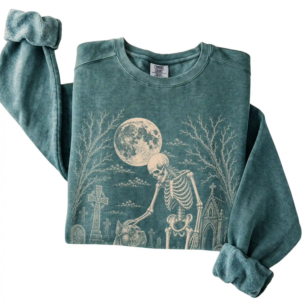 Folded Blue Spruce sweatshirt with a skeleton petting a Cane Corso in a graveyard