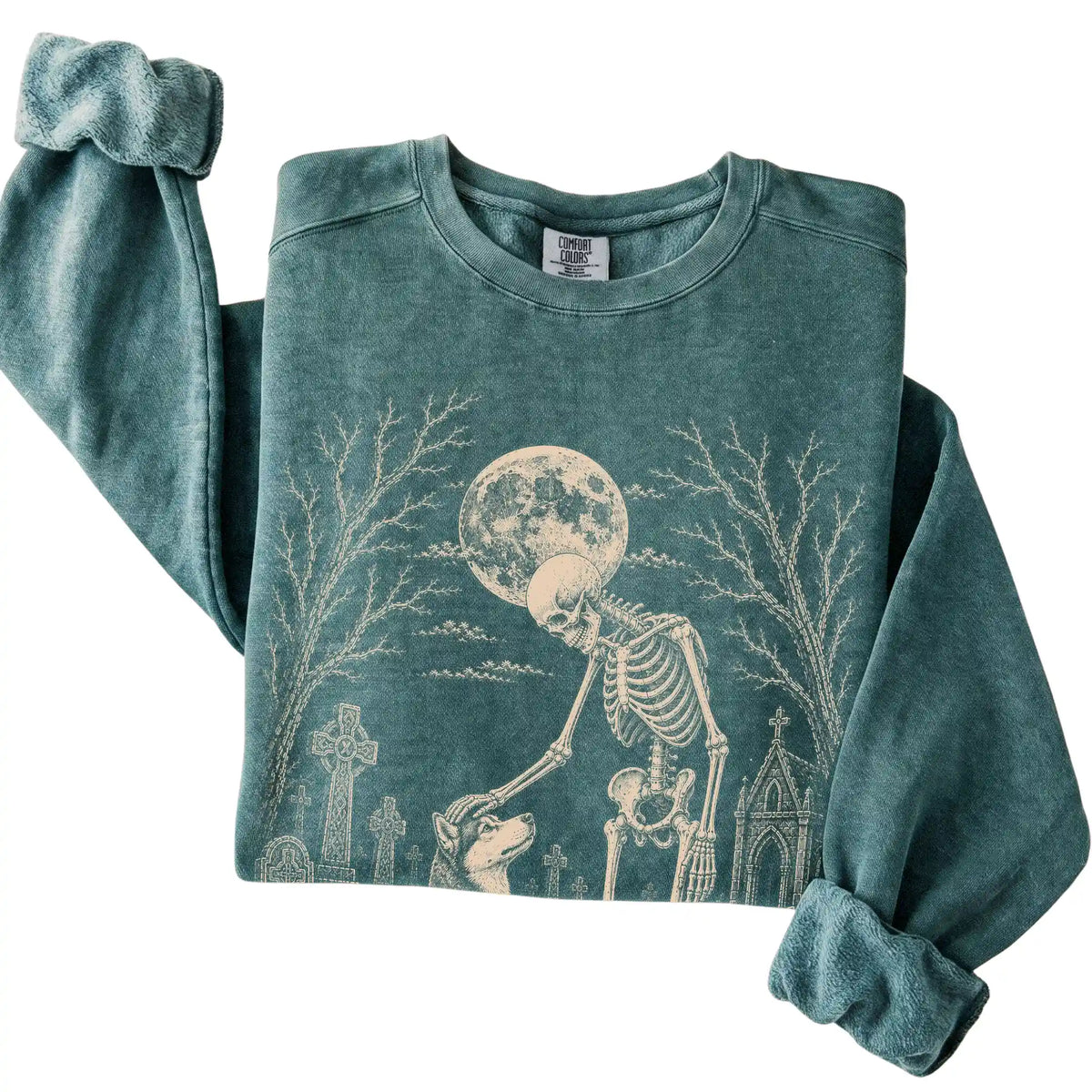 Folded Blue Spruce sweatshirt with a skeleton petting a Husky in a graveyard