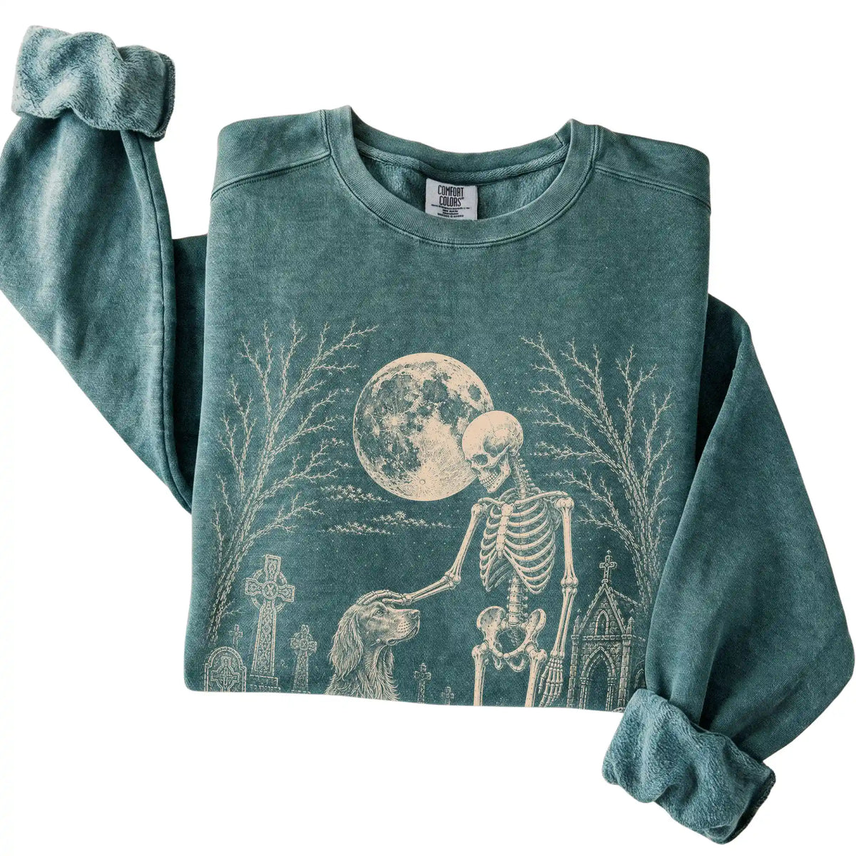 Folded Blue Spruce sweatshirt with a skeleton petting an Irish Setter in a graveyard
