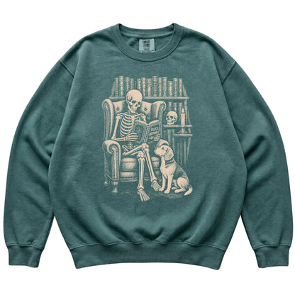 Skeleton reading Tales Beyond to a Beagle on a Blue Spruce sweatshirt
