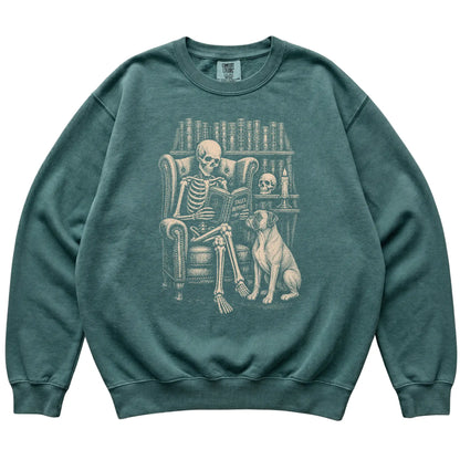 Skeleton reading Tales Beyond to a Boxer on a Blue Spruce sweatshirt