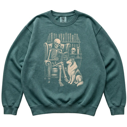 Skeleton reading Tales Beyond to a Collie on a Blue Spruce sweatshirt