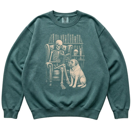 Skeleton reading Tales Beyond to a Mastiff on a Blue Spruce sweatshirt