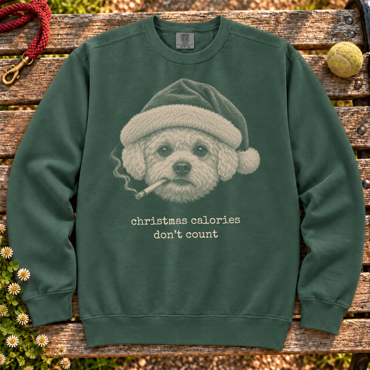 Bichon Frise wearing a Santa hat and smoking on a Blue Spruce sweatshirt