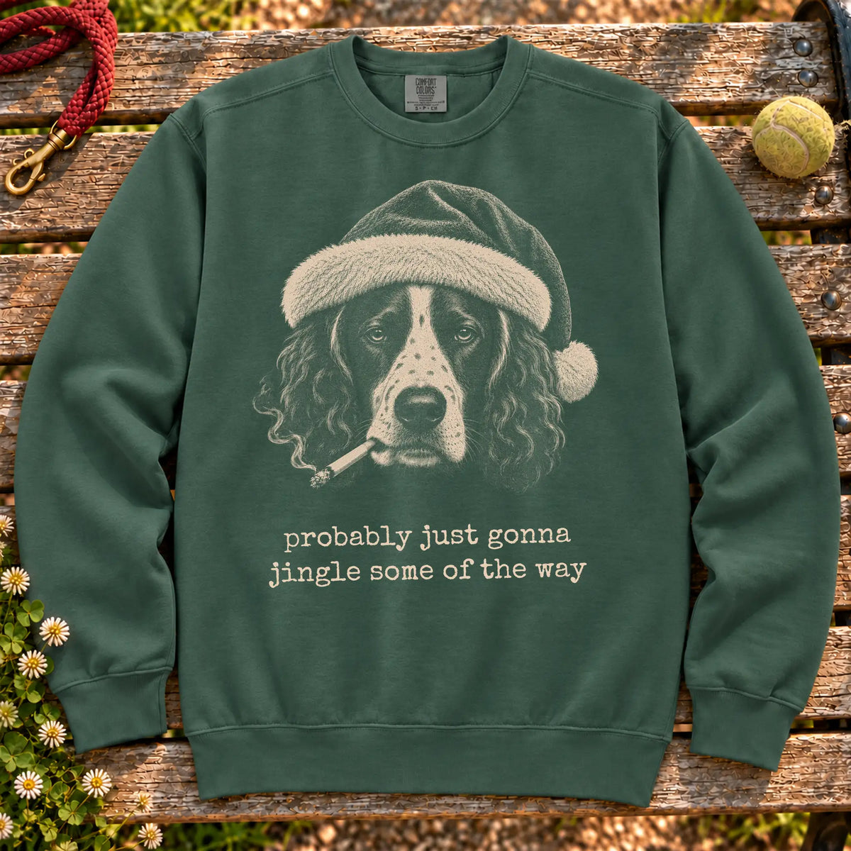 Springer Spaniel wearing a Santa hat and smoking on a Blue Spruce sweatshirt
