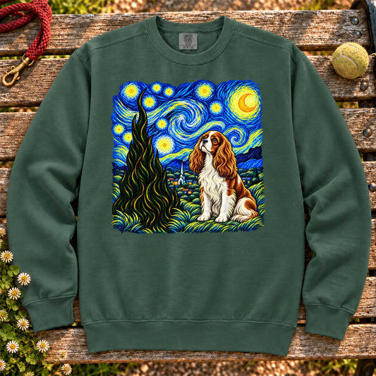 Colorful Cavalier King Charles Spaniel beneath a swirling starry night sky on a Blue Spruce sweatshirt
