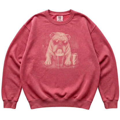 Crimson English Bulldog drinking from a pint at a bar, laid flat