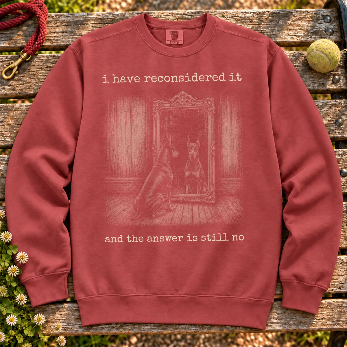 Doberman The Answer Is Still No on a Crimson crewneck sweatshirt, shown flat