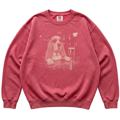 Crimson Basset Hound at a bar beside a pint, laid flat