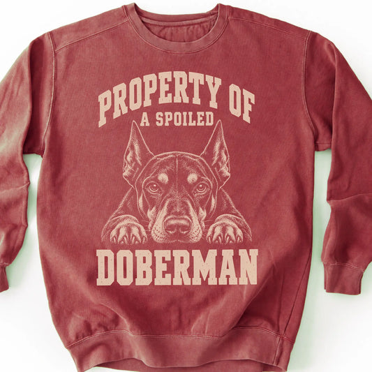 Crimson Doberman sweatshirt with a dog portrait and “Property of a Spoiled” lettering.