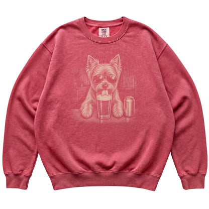 Crimson Yorkie drinking from a pint at a bar, laid flat