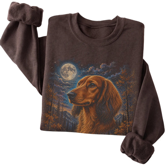Folded dark chocolate sweatshirt with Dachshund Autumn Moon artwork.
