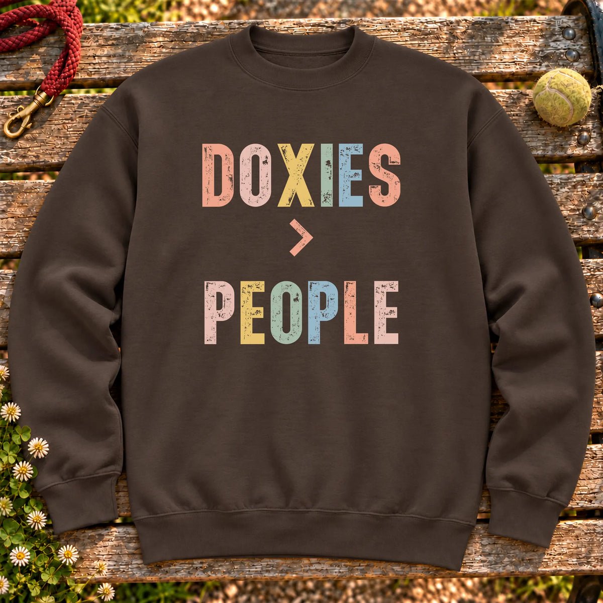 Dachshunds greater than people text design on a Dark Chocolate crewneck sweatshirt