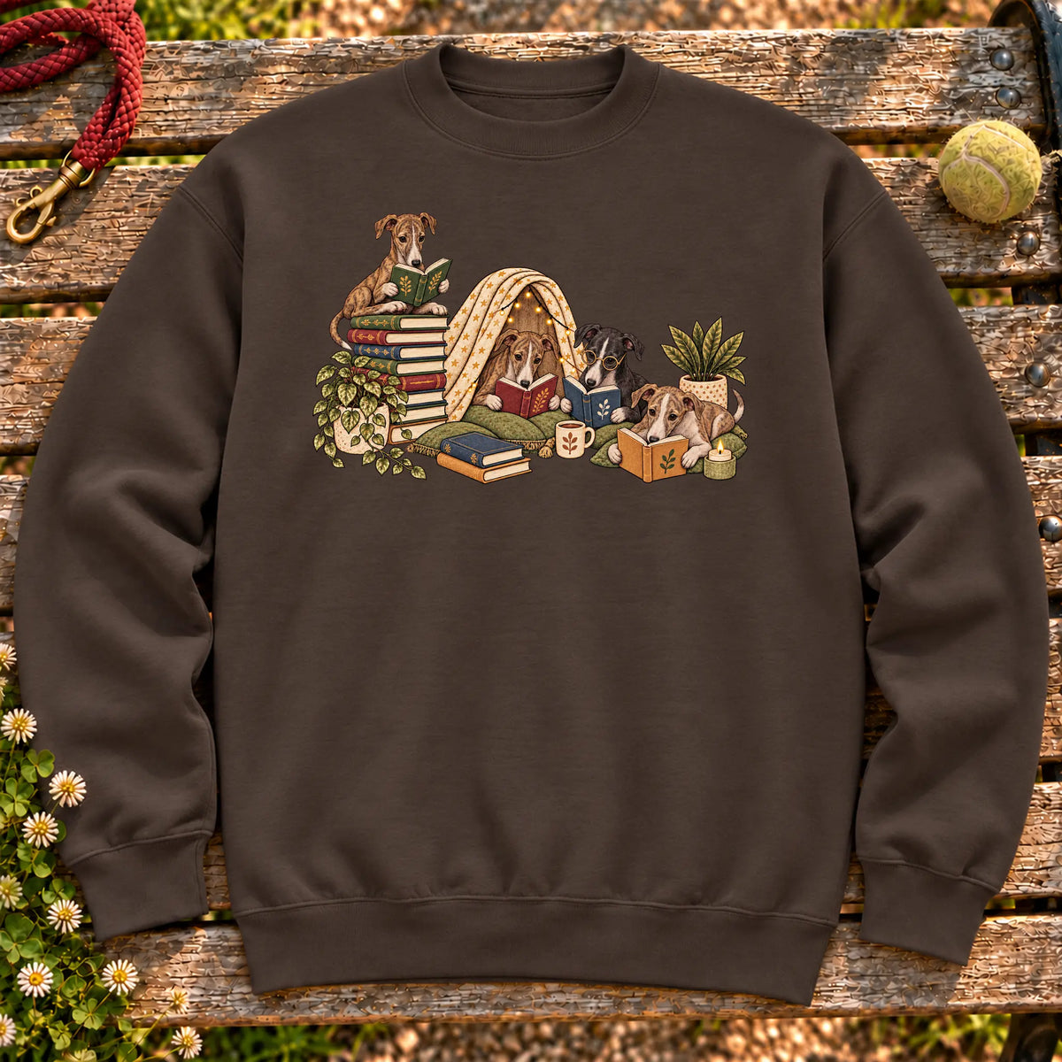 Greyhound puppies reading books in a cozy blanket fort on a Dark Chocolate sweatshirt