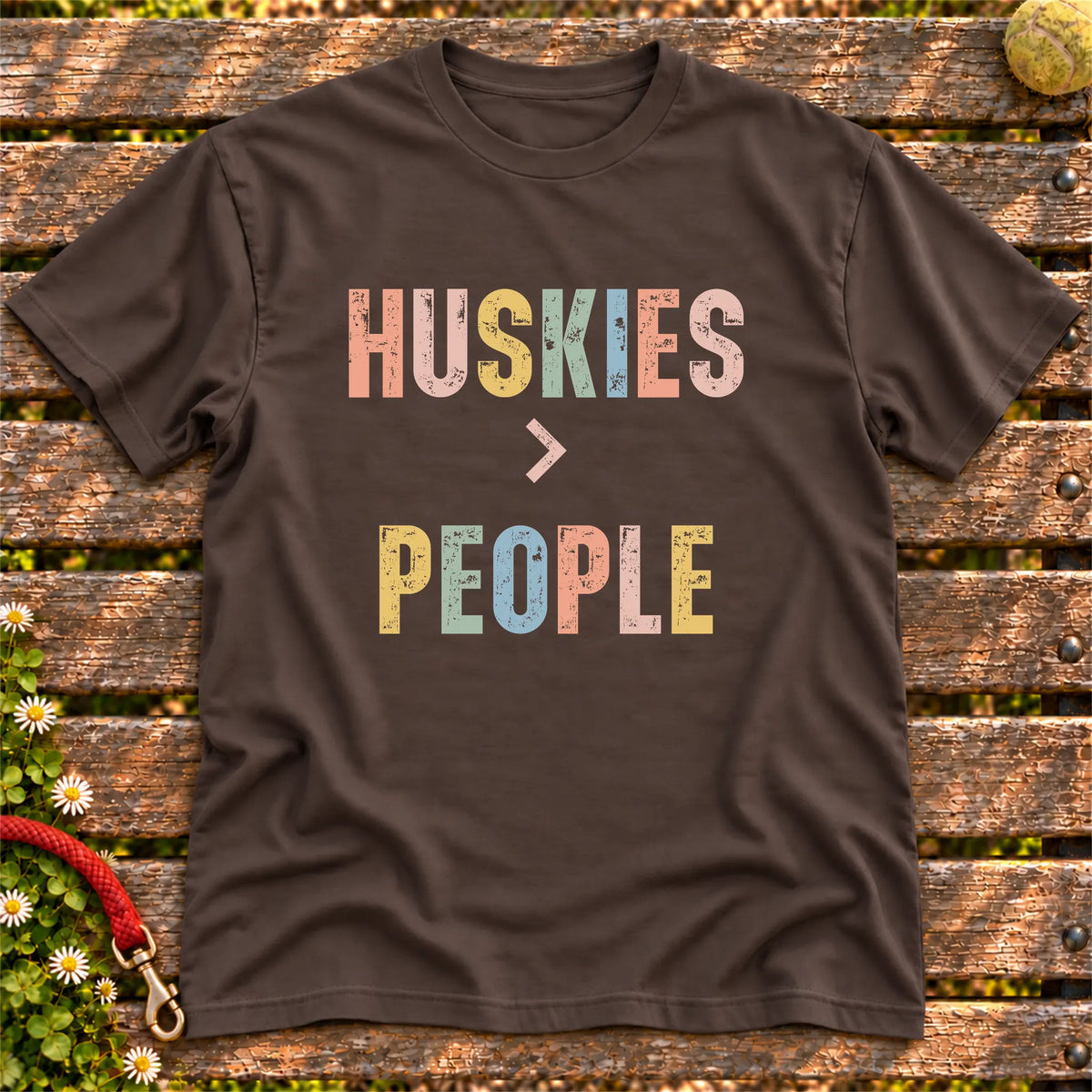 Huskies greater than people text design on a Dark Chocolate softstyle T-shirt