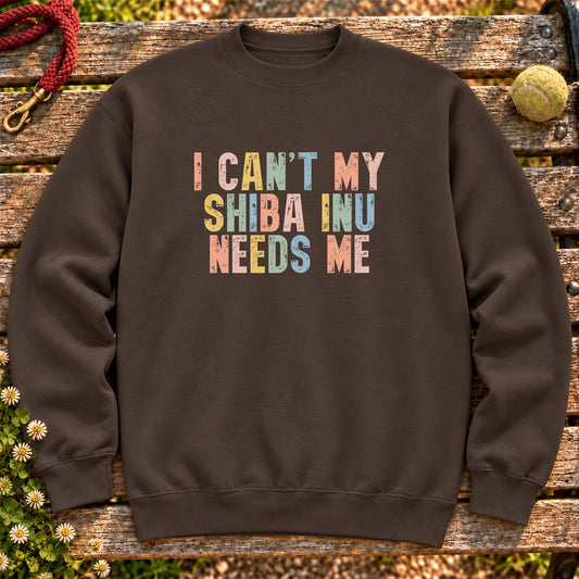 I Can't My Shiba Inu Needs Me text design on a Dark Chocolate crewneck sweatshirt