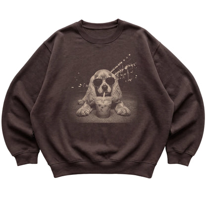 Cocker Spaniel wearing aviator sunglasses and drinking iced coffee on a Dark Chocolate Gildan Heavy Blend Crewneck Sweatshirt, flat lay view