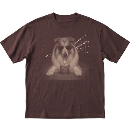 Collie wearing aviator sunglasses and drinking iced coffee on a Dark Chocolate Gildan Softstyle T-Shirt, flat lay view