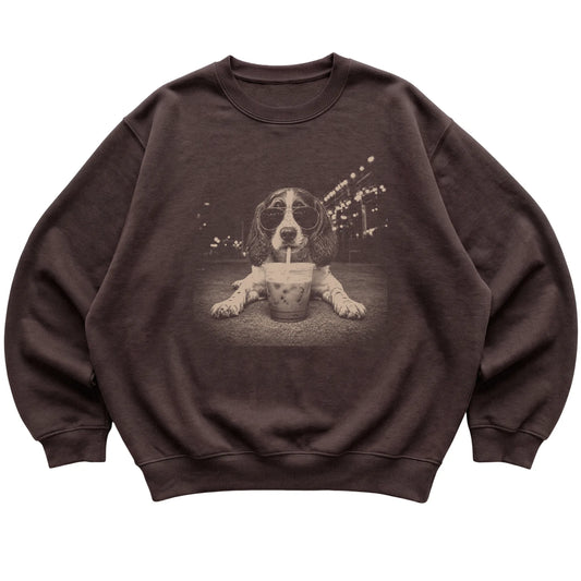 English Springer Spaniel wearing aviator sunglasses and drinking iced coffee on a Dark Chocolate Gildan Heavy Blend Crewneck Sweatshirt, flat lay view
