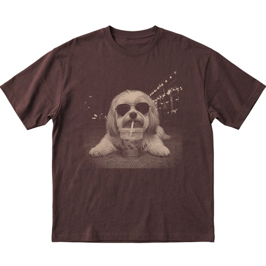 Havanese wearing aviator sunglasses and drinking iced coffee on a Dark Chocolate Gildan Softstyle T-Shirt, flat lay view