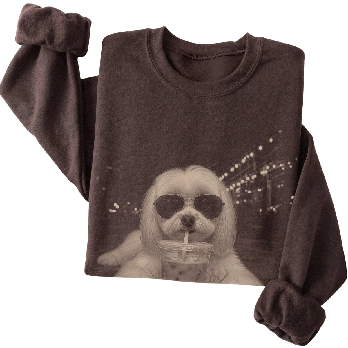 Maltese wearing aviator sunglasses and drinking iced coffee on a Dark Chocolate Gildan Heavy Blend Crewneck Sweatshirt, folded view